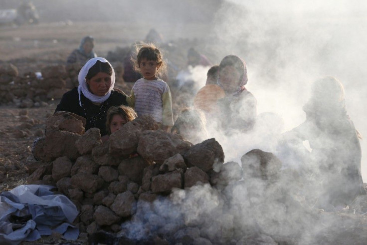 Displaced people from the minority Yazidi sect, who fled violence in the Iraqi town of Sinjar, are seen as they prepare tea for breakfast at Bajed Kadal refugee camp, southwest of Dohuk province, August 23, 2014.