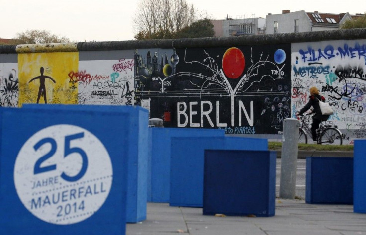 A sign which reads &quot;25 years Fall of the Wall 2014&quot; is pictured in front of sections at the East Side Gallery, the largest remaining part of the former Berlin Wall in Berlin, November 3, 2014.