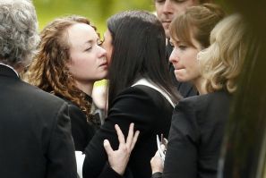 Kerry (L) and Emma (R) Maguire react after the funeral service of their mother, school teacher Ann Maguire at the Church of The Immaculate Heart of Mary in Leeds, northern England May 16, 2014.