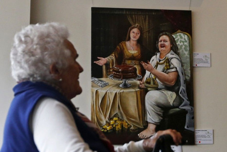 A woman looks at the painting 'The Banquet of Gina and Ginia' by artist Warren Lane at the Bald Archy Prize exhibition in Sydney April 6, 2013. The portrait depicting Australia's iron ore magnate Gina Rinehart eating a chocolate cake as her daughter Ginia