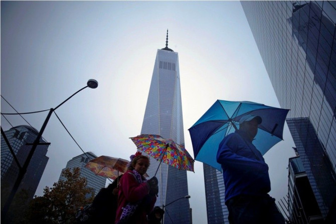 People walk next to the One World Trade Center in New York November 1