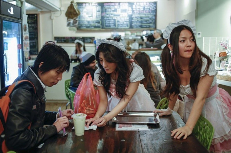 Waitresses at the Maid Cafe New York serve an order at the cafe in New York, November 20, 2013. Originating in Japan, where maid cafes have been around for over a decade, this subset of cosplay restaurants were originally designed primarily to cater to th