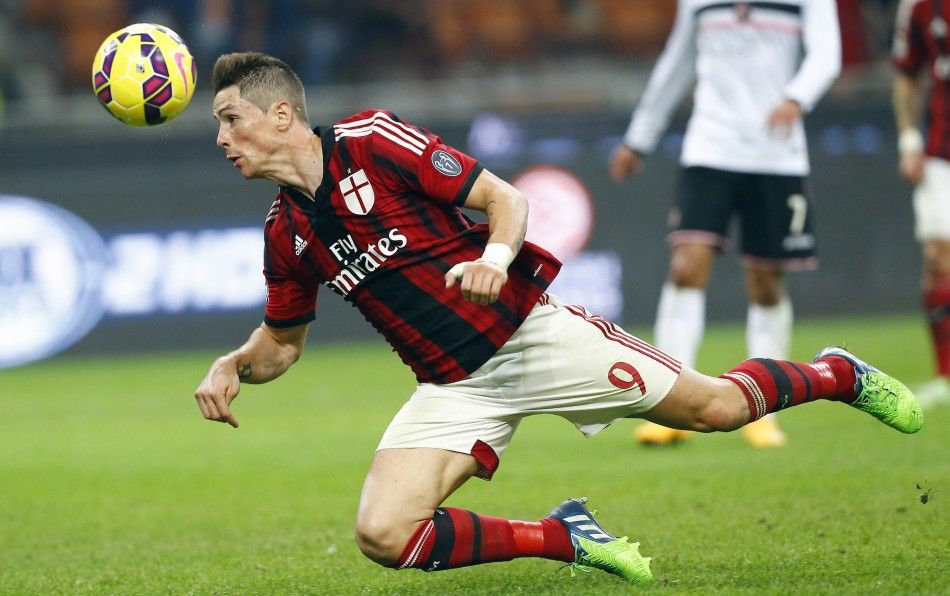 AC Milans Fernando Torres heads the ball during their Serie A soccer match against Palermo at San Siro stadium in Milan, November 2, 2014. 