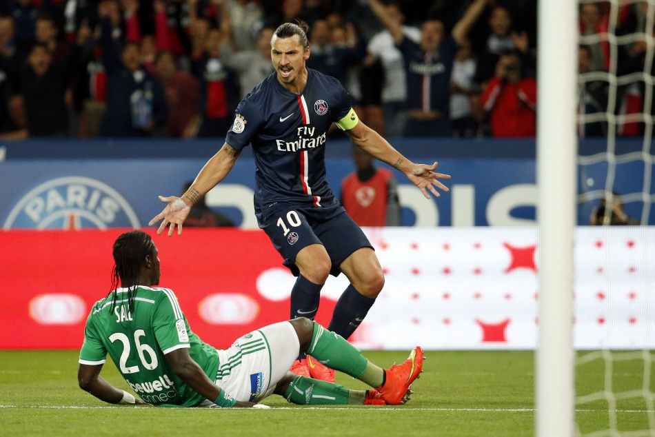 Paris St Germains Zlatan Ibrahimovic R gestures at St Etiennes Bayal Sall as he celebrates scoring a goal during their French Ligue 1 soccer match at the Parc des Princes Stadium in Paris, August 31, 2014. 