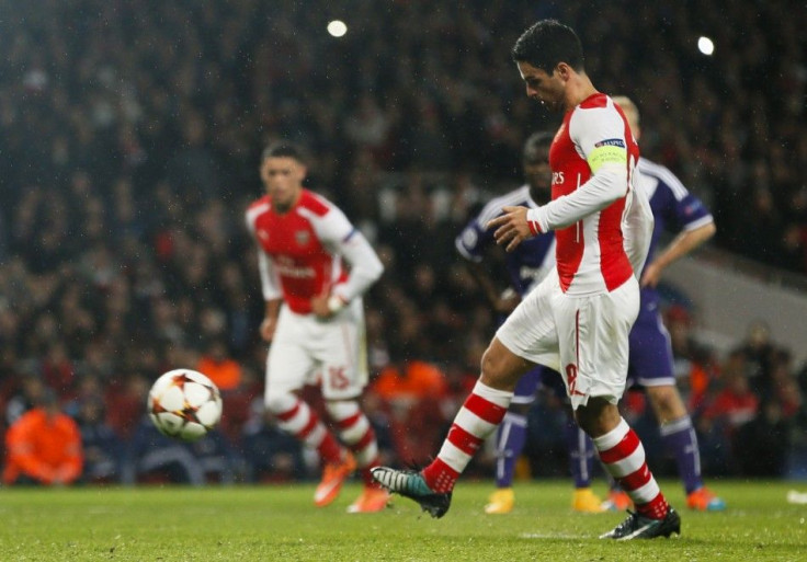 Arsenal's Mikel Arteta scores a penalty against Anderlecht during their Champions League soccer match at the Emirates stadium in London November 4, 2014.