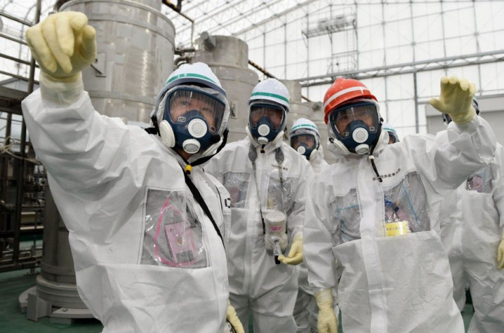 Japan&#039;s new Economy, Trade and Industry Minister Yoichi Miyazawa (R), wearing a protective suit and a mask, inspects the Tokyo Electric Power Co. (TEPCO)&#039;s tsunami-crippled Fukushima Daiichi nuclear power plant in Fukushima prefecture, in this p