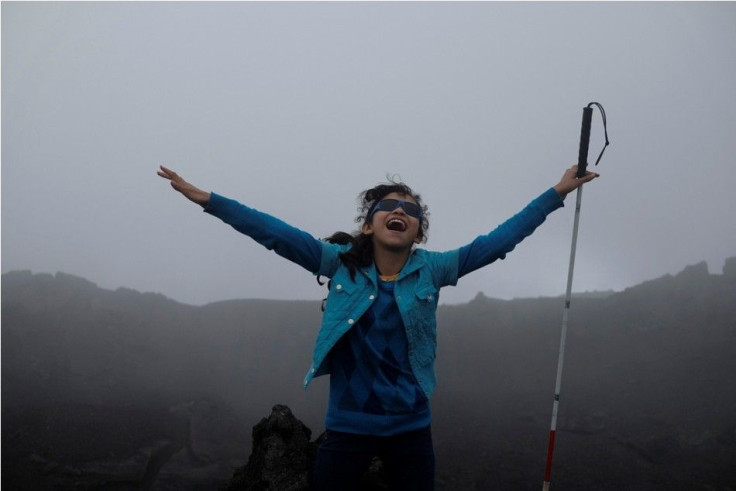 A visually impaired child poses for a picture in the middle of the fog in the Pacaya Volcano in the Escuintla region