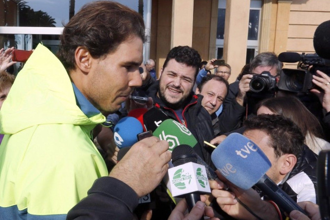 Spanish tennis player Rafael Nadal talks to journalists as he leaves the hospital after appendicitis surgery in Barcelona November 5, 2014. REUTERS/Gustau Nacarino