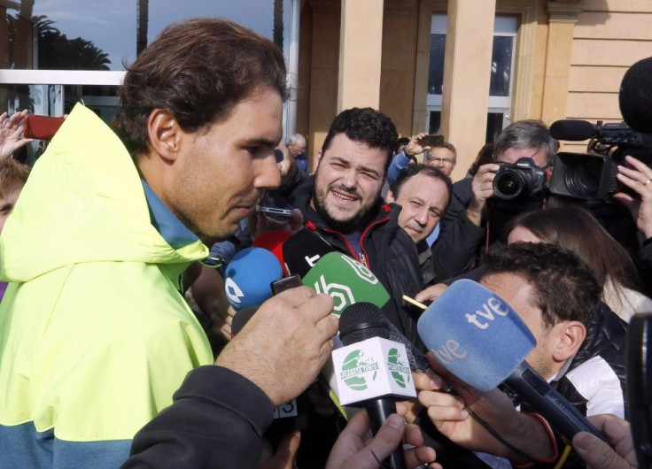 Spanish tennis player Rafael Nadal talks to journalists as he leaves the hospital after appendicitis surgery in Barcelona November 5, 2014. REUTERS/Gustau Nacarino