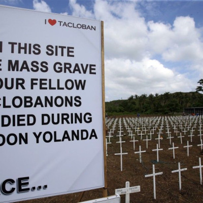 A sign and wooden crosses are placed for victims of Typhoon Haiyan at a mass grave in Tacloban city in central Philippines November 5, 2014. The Philippines are preparing to commemorate victims of Typhoon Haiyan, ahead of the one-year anniversary of the d