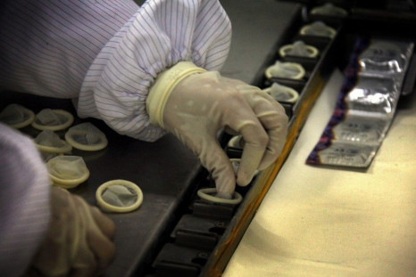 A worker places condoms onto a packaging belt at the Chinese condom manufacturer Safedom's factory in the town of Zhaoyuan, located 100 km (62 miles) south of the city of Yantai, Shandong Province February 6, 2012.
