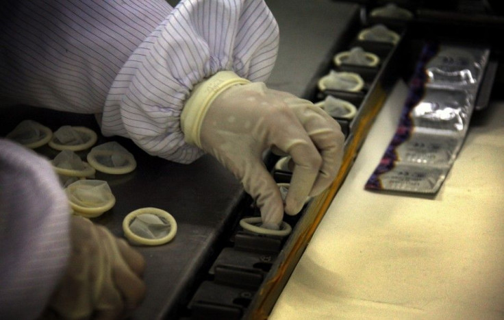 A worker places condoms onto a packaging belt at the Chinese condom manufacturer Safedom's factory in the town of Zhaoyuan, located 100 km (62 miles) south of the city of Yantai, Shandong Province February 6, 2012.