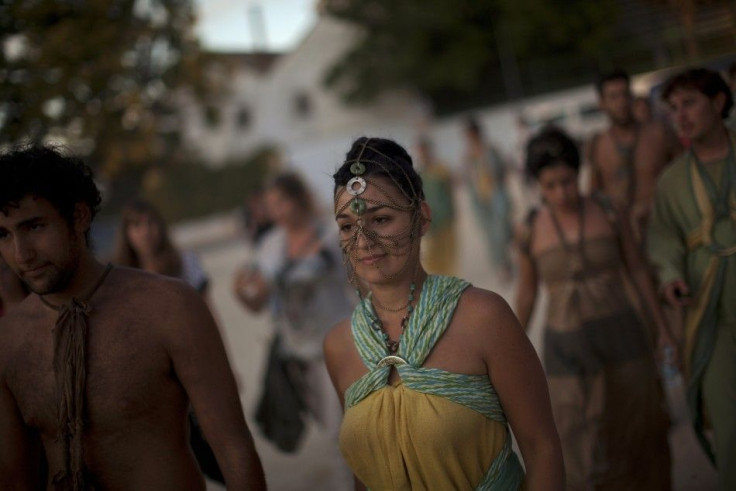 Extras walk along a street after taking part in the filming of the fifth season of the HBO fantasy drama TV series &quot;Game of Thrones&quot;