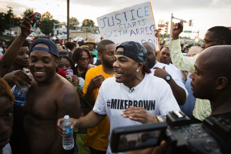 Rapper Nelly (C) takes part in a peaceful march in reaction to the shooting of Michael Brown near Ferguson, Missouri August 18, 2014. Missouri's governor lifted the curfew for the St. Louis suburb of Ferguson on Monday as National Guard troops were called
