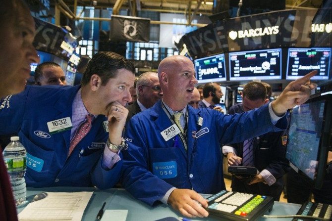 Traders work on the floor of the New York Stock Exchange shortly after the markets open in New York November 7, 2014.