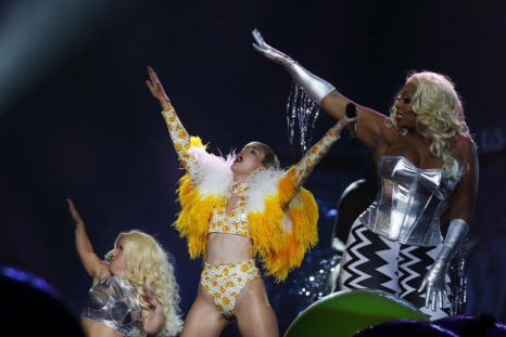 U.S. singer Miley Cyrus (C) performs at the Arena Ciudad de Mexico in Mexico City, September 19, 2014.