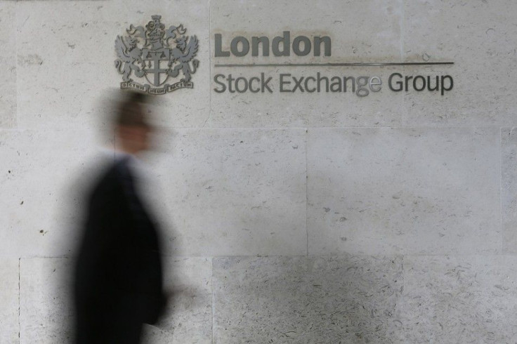 A man walks past the London Stock Exchange in the City of London October 11, 2013. Shares in Britain's Royal Mail rocketed to a near 40 percent premium above their issue price in Friday's stock market debut, fuelling a debate about whether they had been p