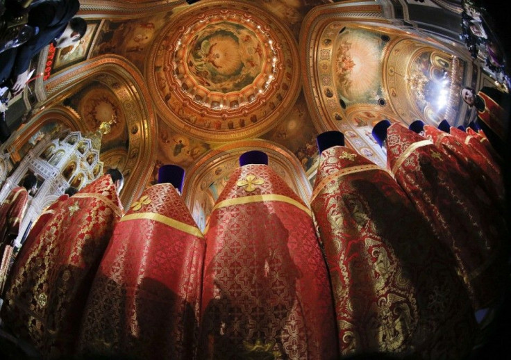 Russian Orthodox priests attend an Easter service in the Christ the Saviour Cathedral in Moscow, April 20, 2014. Picture taken with a fisheye lens. REUTERS/Maxim Shemetov