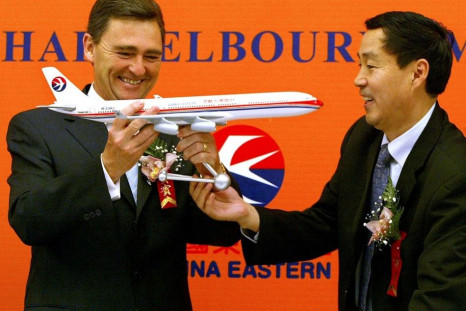 Peoples Republic ofWan Mingwu (R), Director and Vice-President of China Eastern, hands a model of a China Eastern plane to Australian MP John Brumby, during a news conference in Shanghai December 5, 2003. China Eastern, the mainland's second-largest carri