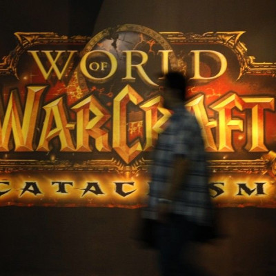 A visitor walks past a placard of 'World of Warcraft' at their exhibition stand at the Gamescom 2010 fair in Cologne August 18, 2010. The Gamescom convention, Europe's largest video games trade fair, runs from August 18 to August 22. 