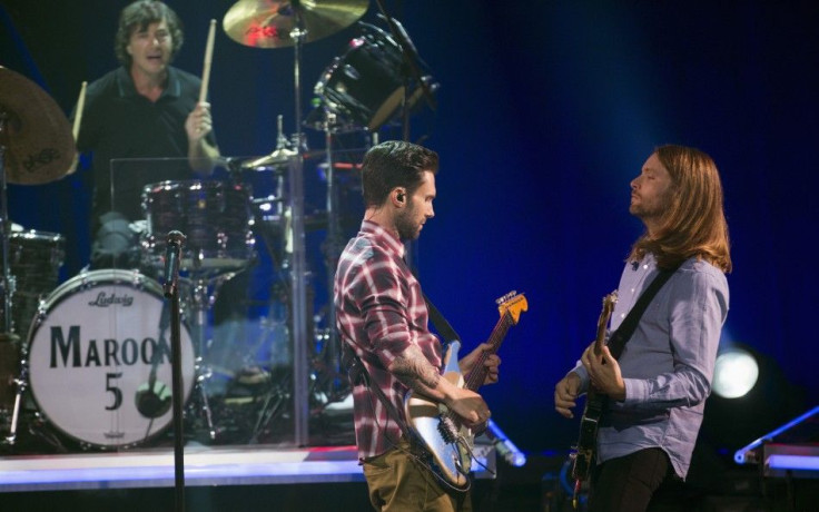 Vocalist Adam Levine (C), guitarist James Valentine (R) and drummer Matt Flynn of pop rock band Maroon 5 perform during the band&#039;s album release party for &quot;V&quot; at the iHeartRadio theatre in Burbank, California August 26, 2014.