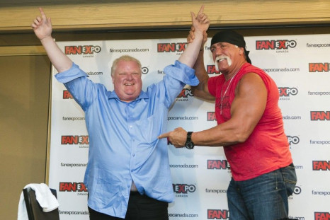 Toronto Mayor Rob Ford (L) celebrates after arm wrestling former professional wrestler Hulk Hogan to mark the beginning of the &quot;Fan Expo&quot; in Toronto, August 23, 2013.