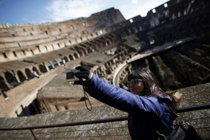 A woman takes a picture of herself in Rome&#039;s ancient Colosseum January 18, 2013. Italian restorers cleaning the Colosseum have discovered remains of frescoes indicating the interior of one of the world&#039;s most famous monuments may have been colou