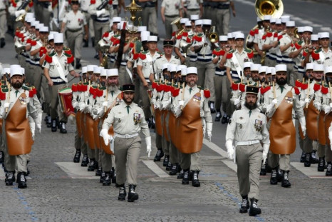 Pioneers of the 1st Foreign Legion regiment carry their axes as they march during the traditional Bastille Day parade on the Place de la Concorde in Paris, July 14, 2014. REUTERS/Benoit Tessier