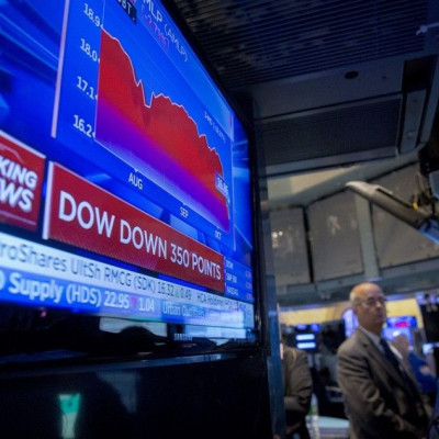 A screen displays news on the Dow Jones Industrial Average just after the opening bell on the floor of the New York Stock Exchange October 15, 2014. U.S. stocks opened sharply lower on Wednesday as economic data reinforced concerns about the health of the
