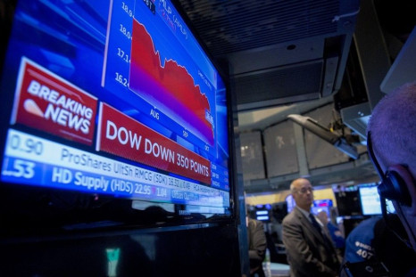 A screen displays news on the Dow Jones Industrial Average just after the opening bell on the floor of the New York Stock Exchange October 15, 2014. U.S. stocks opened sharply lower on Wednesday as economic data reinforced concerns about the health of the