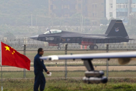 A J-31 stealth fighter (background) of the Chinese People&#039;s Liberation Army Air Force lands on a runway after a flying performance at the 10th China International Aviation and Aerospace Exhibition in Zhuhai, Guangdong province, November 11, 2014. Chi