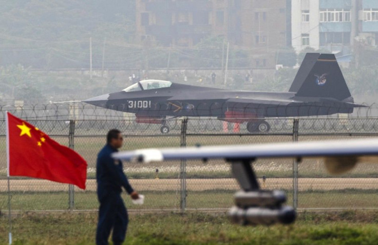 A J-31 stealth fighter (background) of the Chinese People&#039;s Liberation Army Air Force lands on a runway after a flying performance at the 10th China International Aviation and Aerospace Exhibition in Zhuhai, Guangdong province, November 11, 2014. Chi