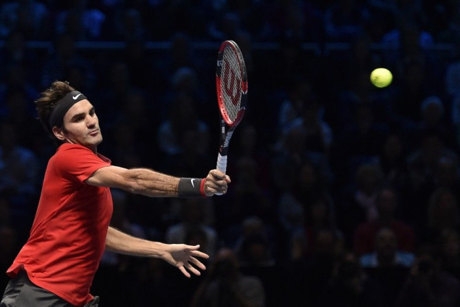 Roger Federer of Switzerland returns the ball to Kei Nishikori of Japan during their tennis match at the ATP World Tour finals at the O2 Arena in London November 11, 2014. REUTERS/Toby Melville