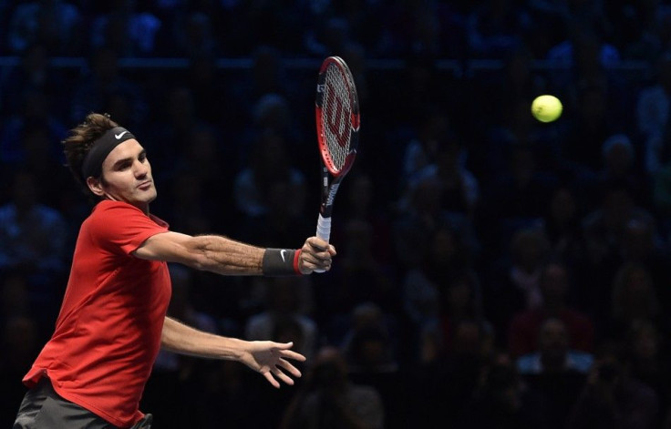 Roger Federer of Switzerland returns the ball to Kei Nishikori of Japan during their tennis match at the ATP World Tour finals at the O2 Arena in London November 11, 2014. REUTERS/Toby Melville