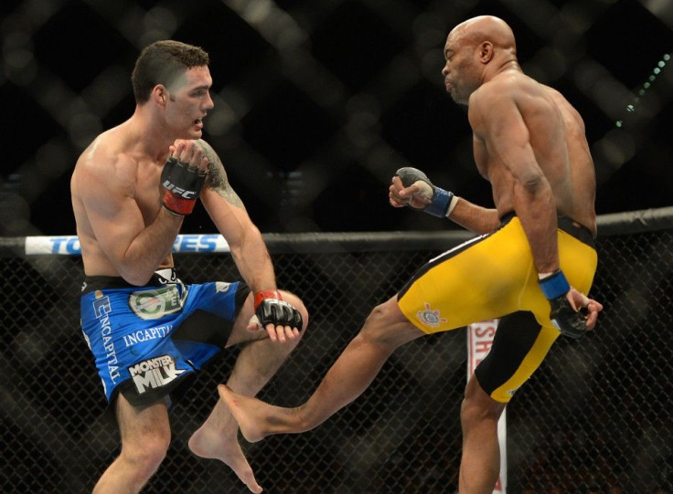 Dec 28, 2013; Las Vegas, NV, USA; (EDITORS NOTE: graphic content) Anderson Silva (blue gloves) breaks his leg on a kick to Chris Weidman (red gloves) during their UFC middleweight championship bout at the MGM Grand Garden Arena.