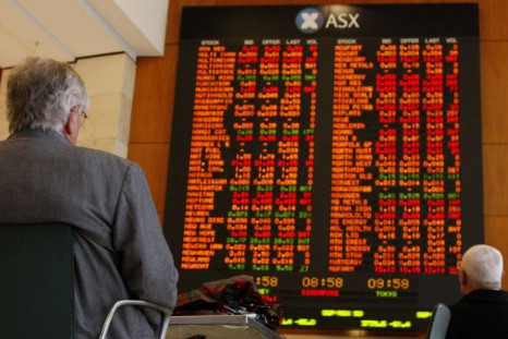 Men watch the stock board at the Australian Securities Exchange (ASX) in central Sydney April 21, 2009. Australian stocks fell 2.6 percent on Tuesday, led down by banks and miners, on fresh concerns about the earnings outlook for domestic companies and a 