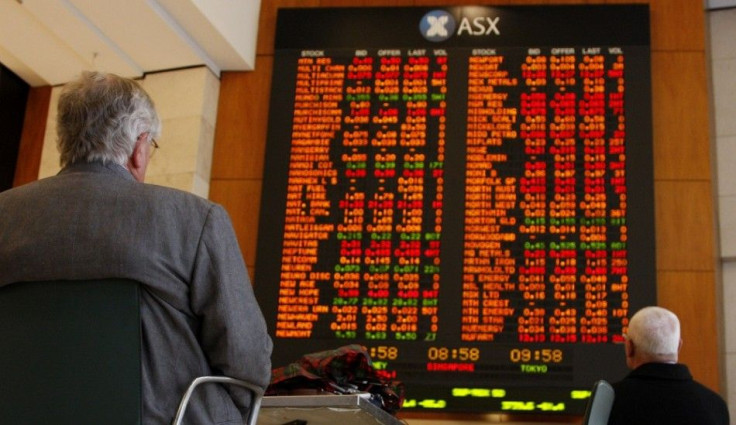 Men watch the stock board at the Australian Securities Exchange (ASX) in central Sydney April 21, 2009. Australian stocks fell 2.6 percent on Tuesday, led down by banks and miners, on fresh concerns about the earnings outlook for domestic companies and a 