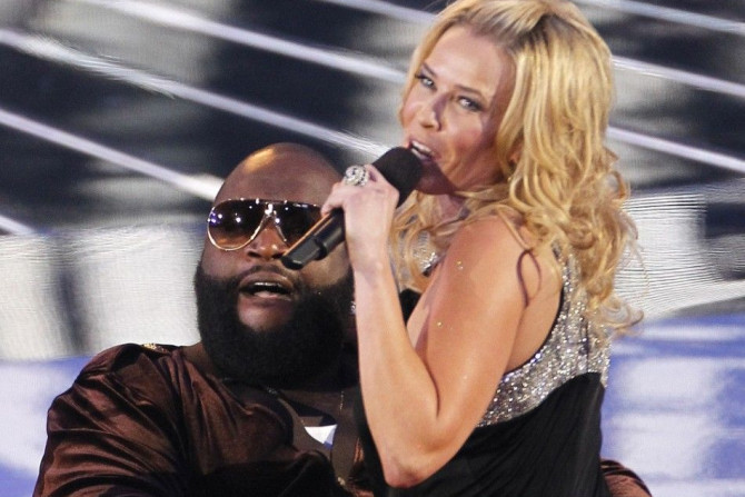 Chelsea Handler, host of the 2010 MTV Video Music Awards, sits on the lap of Rick Ross as they leave the stage on a scooter in Los Angeles, California, September 12, 2010.
