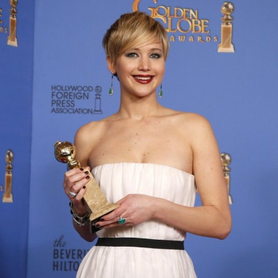 Actress Jennifer Lawrence poses with her award for Best Supporting Actress in a Motion Picture for her role in the film &quot;American Hustle&quot; backstage at the 71st annual Golden Globe Awards in Beverly Hills, California January 12, 2014.