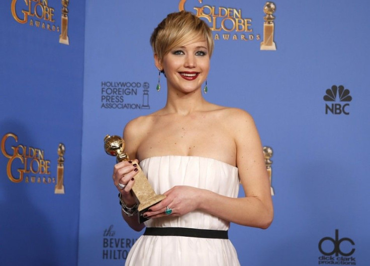 Actress Jennifer Lawrence poses with her award for Best Supporting Actress in a Motion Picture for her role in the film &quot;American Hustle&quot; backstage at the 71st annual Golden Globe Awards in Beverly Hills, California January 12, 2014.