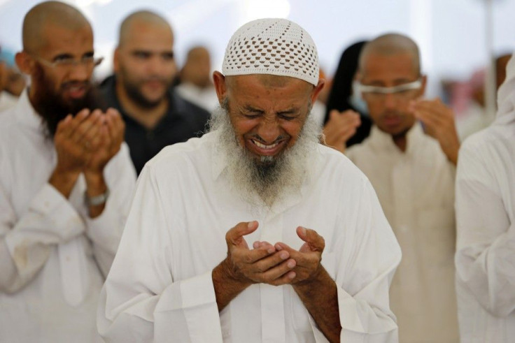 Muslim pilgrims pray after they cast stones at pillars symbolizing Satan, during the annual Haj pilgrimage on Eid al-Adha in Mina, near the holy city of Mecca