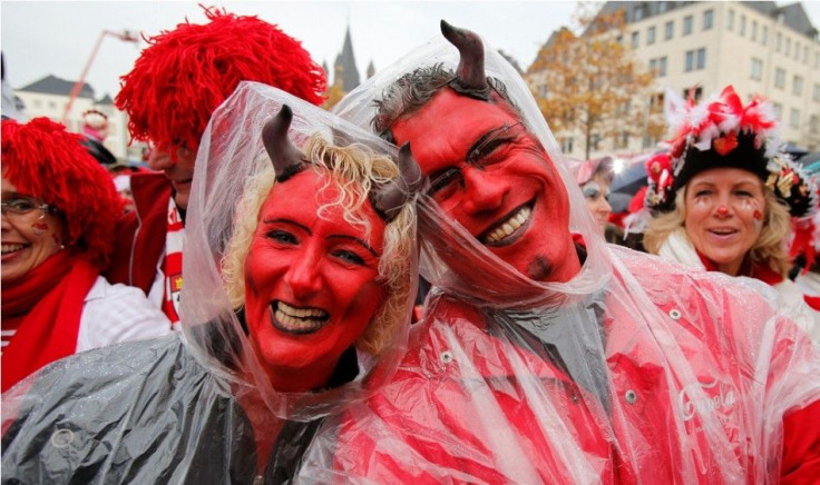 Carnival revellers pose for a picture as they attend the start of the carnival season in Cologne