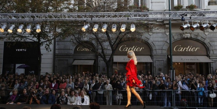 Spectators look at a model presenting outfit during an open air show Prague Fashion Weekend at Prague's Parizska street September 24, 2011.