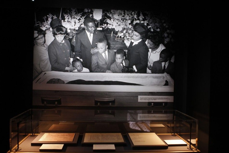 The death certificate of Martin Luther King, Jr., along with other documents following his assassination, is seen below a picture of the family at his funeral, at the new National Center for Civil and Human Rights in Atlanta, Georgia June 19, 2014.