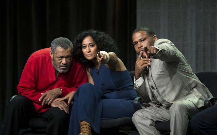 Cast member and executive producer Anthony Anderson (R) gestures next to co-stars Laurence Fishburne (L) and Tracee Ellis Ross