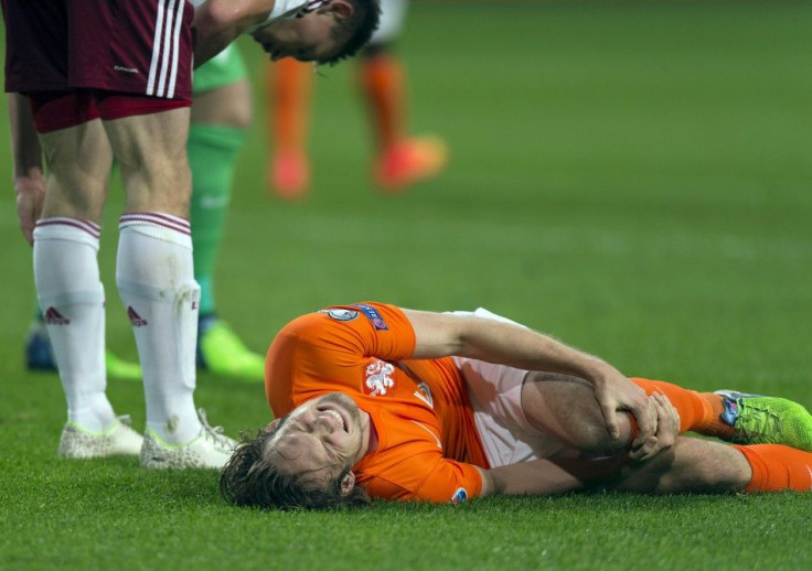 Daley Blind of the Netherlands lies injured after a challenge with Latvia's Eduards Viskanovs during their Euro 2016 Group A qualifying soccer match in Amsterdam November 16, 2014.