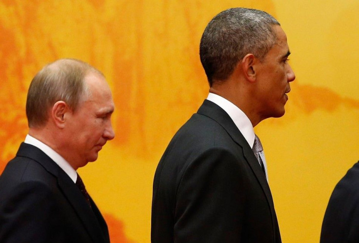 U.S. President Barack Obama (R) and Russia's President Vladimir Putin attend a family photo shoot for the Asia Pacific Economic Cooperation (APEC) leaders' meeting at the International Convention Center at Yanqi Lake in Beijing, November 11, 201