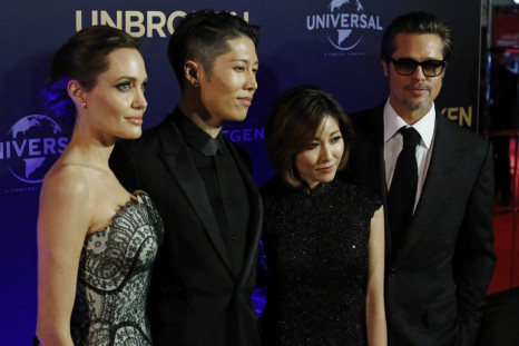 Angelina Jolie (L-R), cast member Miyavi, his wife Melody Ishihara and Brad Pitt pose at the world premiere of Jolie&#039;s film &quot;Unbroken&quot; at the State Theatre in Sydney November 17, 2014.