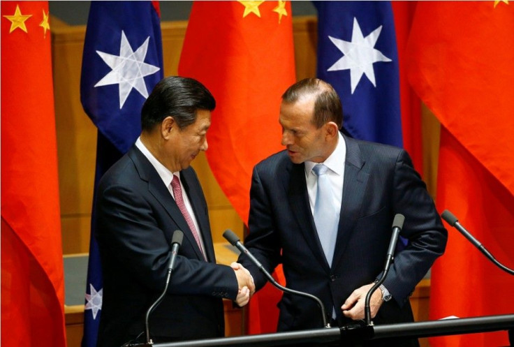 China?s President Xi Jinping (L) shakes hands with Australian Prime Minister Tony Abbott after a signing ceremony for a free trade deal at Parliament House in Canberra