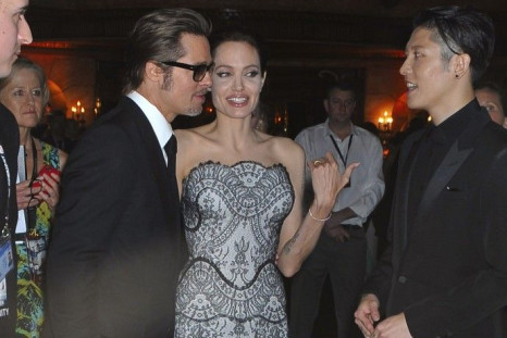 Angelina Jolie and Brad Pitt speak with Japanese actor Miyavi at the world premiere of Jolie's film &quot;Unbroken&quot; at the State Theatre in Sydney November 17, 2014. The war drama, based on the life of World War Two American prisoner of war Louis Zam